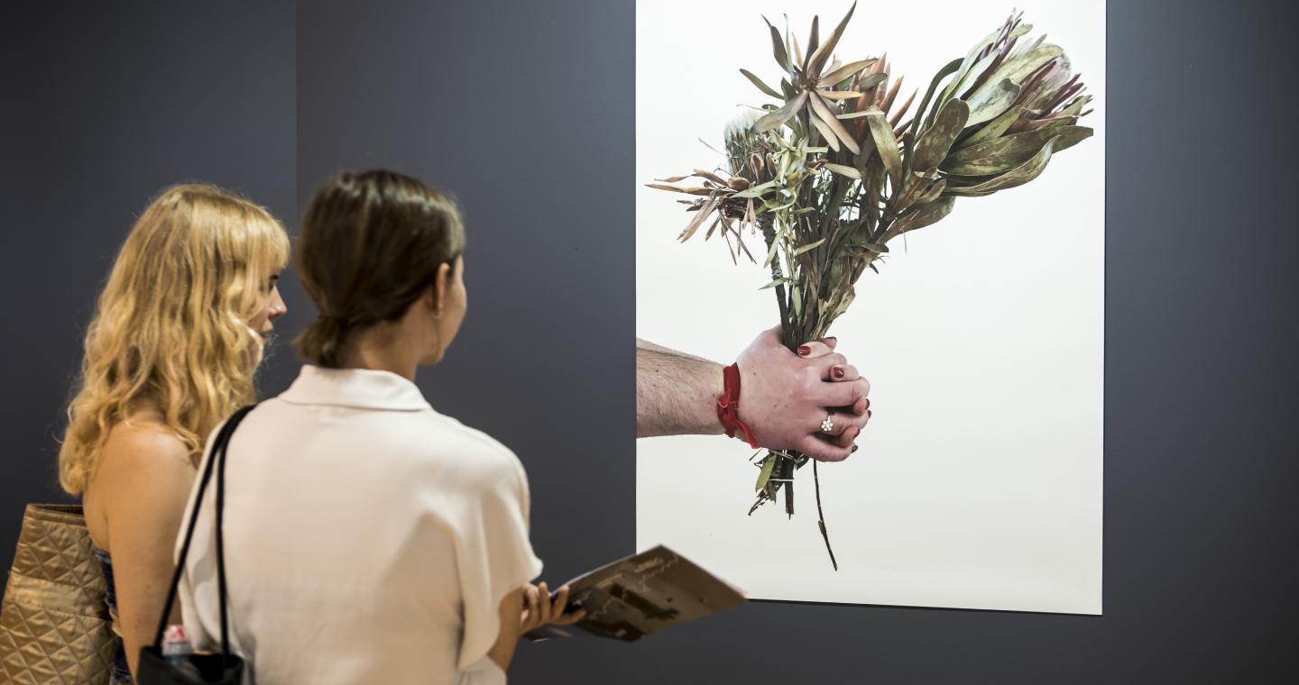 Two girls looking at art work